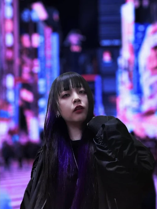 Model against neon city lights at night