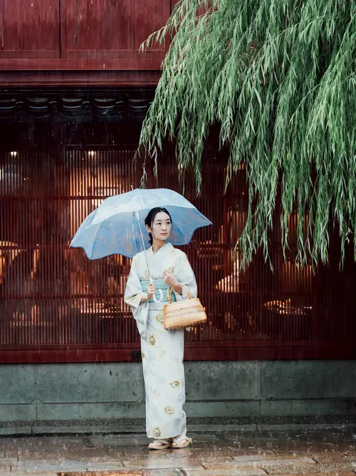 Model in a summer kimono with a clear umbrella in the rain